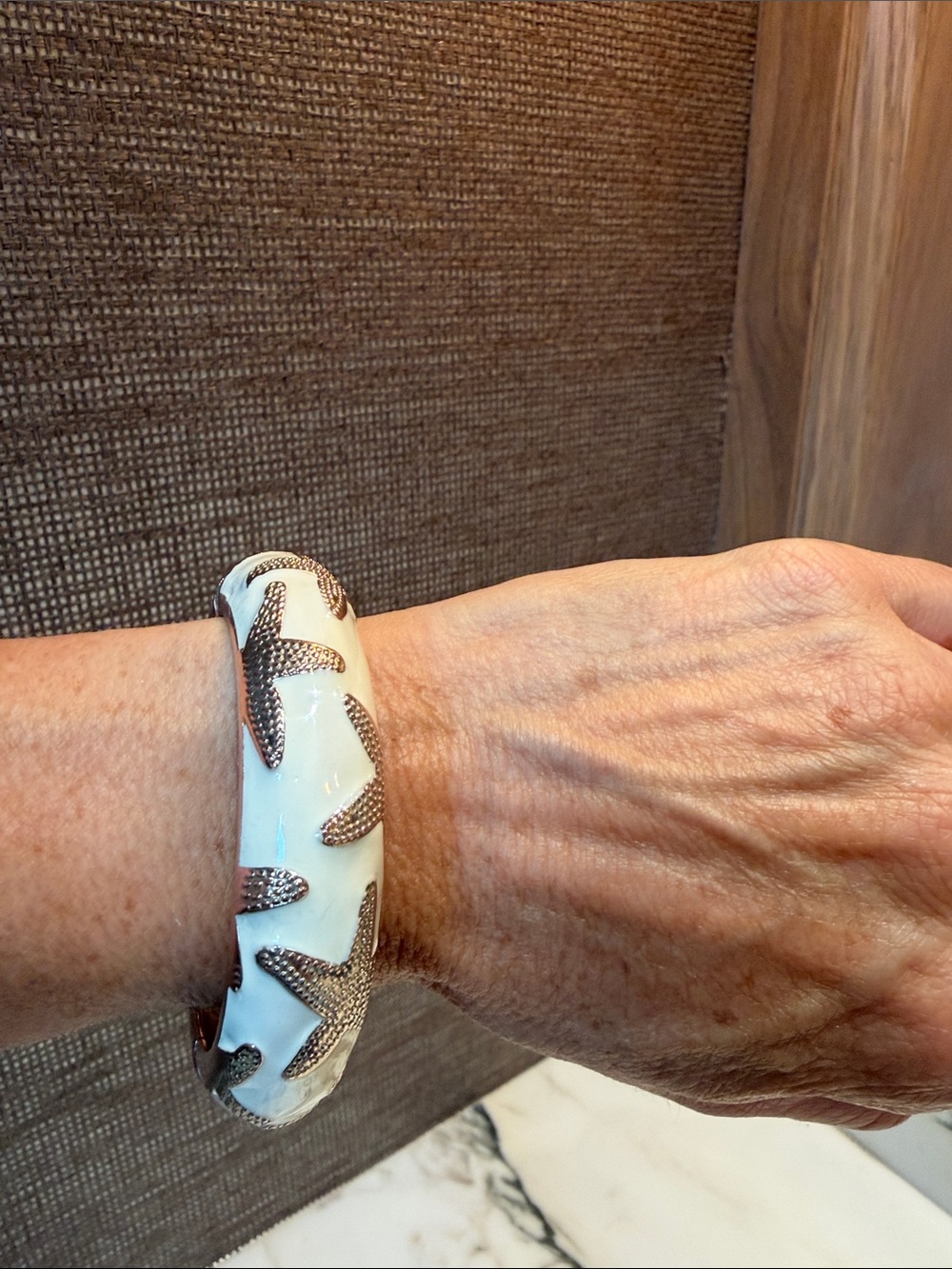 White enamel Bangle Bracelet with Textured gold tone Starfish Accents